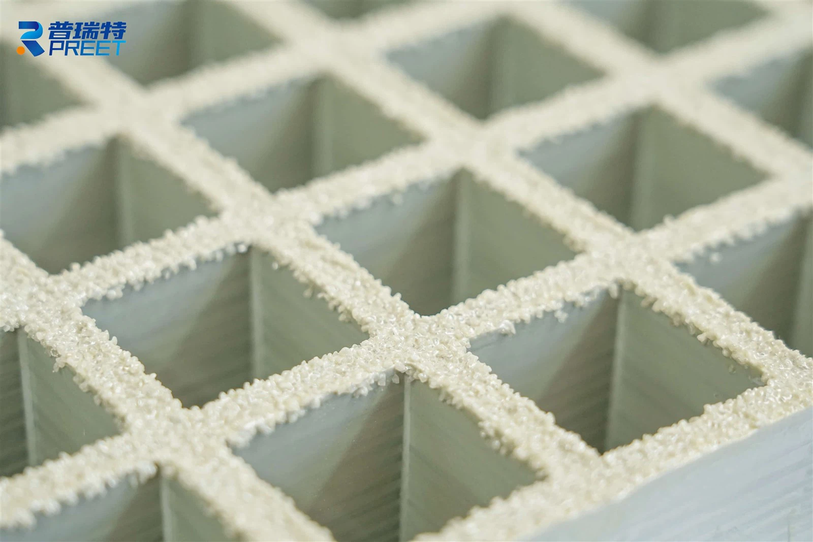 FRP grating surface finish showing anti-slip grit treatment FRP grating surface finish showing anti-slip grit treatment